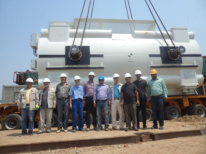 The construction team of Bibiyana power plant poses with the plant's equipment at the project site. Photo: Summit
