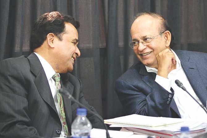 Planning Minister AHM Mostafa Kamal and Environment and Forest Minister Anwar Hossain Manju, inset, share a light moment during a roundtable, 'Development of Southwest Region and Protecting the Sundarbans', organised by The Daily Star at The Daily Star Centre in the capital yesterday.