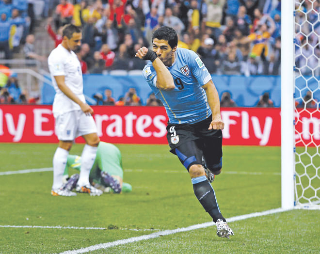 Uruguay's talismanic forward Luis Suarez celebrates his opening goal against England during their World Cup Group D match at the Corinthians Arena in Sao Paulo yesterday. Suarez later scored another one as Uruguay won 2-1.  PHOTO: AFP