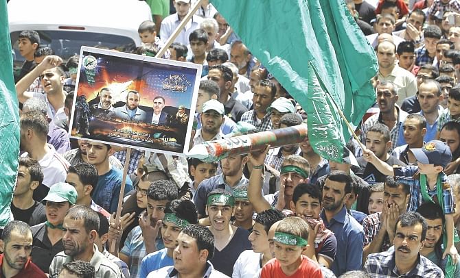 Supporters of the Palestinian Islamist Hamas movement gather during a demonstration in the West Bank city of Nablus to support people in the Gaza Strip yesterday. Five Palestinians were killed in new Israeli air strikes on Gaza yesterday, raising the death toll since July 8 to 2,087 Palestinians dead and 67 Israelis.  Photo: AFP 