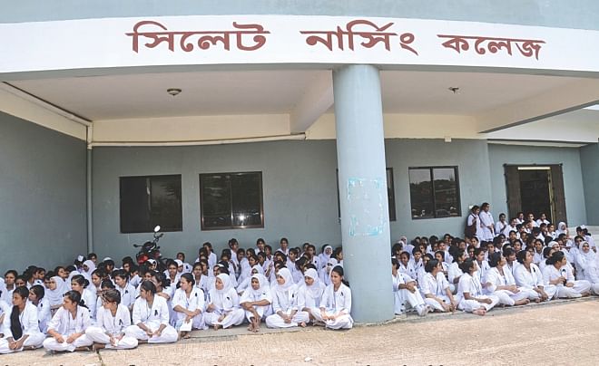 Students of Sylhet Nursing College stage a sit-in on the campus yesterday protesting an attack on some student nurses allegedly by interns at MAG Osmani Medical College Hospital. Photo: Star