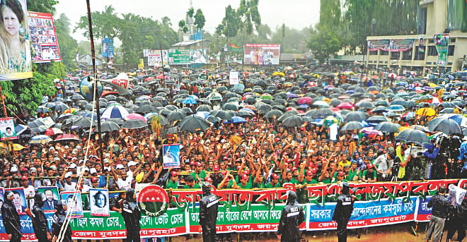 Braving rains, supporters and activists attend a BNP rally in Joypurhat yesterday. The rally, organised by the district unit of the BNP, was addressed by party chief Khaleda Zia. Photo: Courtesy