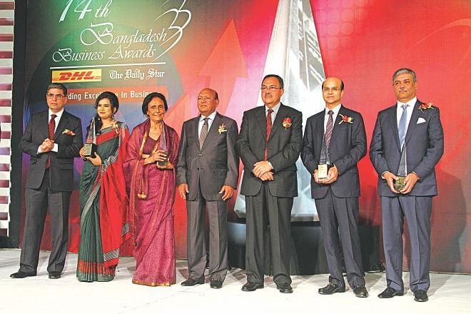 From left, Sanjiv Mehta, executive vice president of Unilever South Asia, and managing director and CEO of Hindustan Unilever; Tania Wahab, managing partner of Karigar; Laila Rahman Kabir, managing director of Kedarpur Tea Company; Tofail Ahmed, commerce minister; Desmond Quiah, country manager of DHL Worldwide Express (Bangladesh); Quazi M Shariful Ala, managing director of Delta Brac Housing Finance Corporation; and Yasin Ali, managing director of Habib Group, pose for photographs at the Bangladesh Business Awards ceremony at Sonargaon Hotel in Dhaka last night.  photo: Amran Hossain