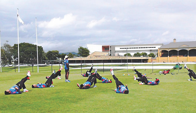 The Tigers are seen engaged in a synchronised stretching session at the Allan Border Ground yesterday in Brisbane, where they are now based as part of their preparation for the World Cup.  Photo: BCB