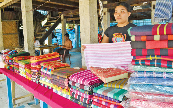 A Rakhaine woman sells clothes at her shop in Misripara. 