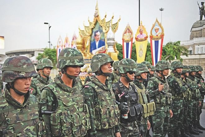 Thai soldiers take control of an area during the anti-coup protest. Thailand's coup leader received royal endorsement to lead the politically divided kingdom on May 26 and quickly issued a stark warning that he would brook no further opposition to his takeover following a weekend of angry protests. 