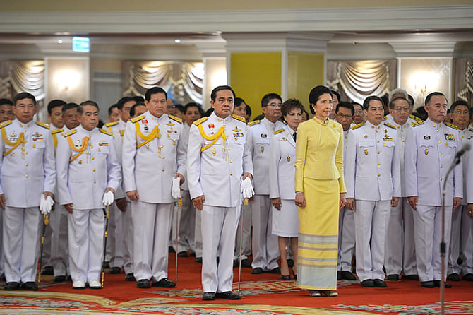 Thailand's newly appointed Prime Minister Prayuth Chan-ocha stands with his wife Naraporn during the royal endorsement ceremony at the Royal Army headquarters in Bangkok in this August 25, 2014 handout photo provided by the Thailand Government House. Photo: Reuters