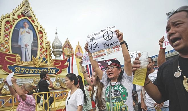 Anti-coup protesters shout slogans during a rally at Victory monument in Bangkok yesterday.