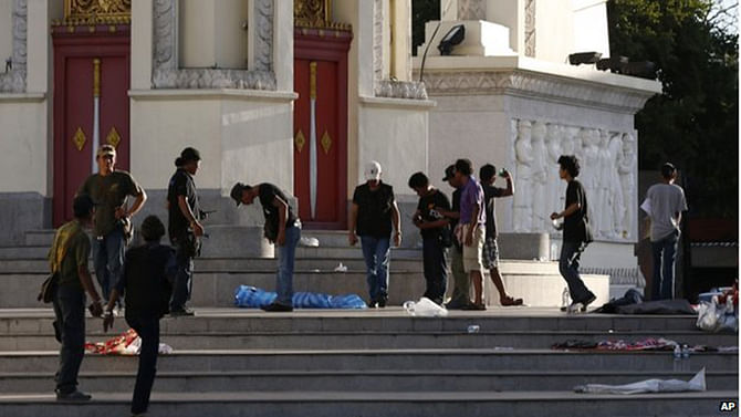 Protesters cleaned the steps of the Democracy Monument in Bangkok on Thursday morning