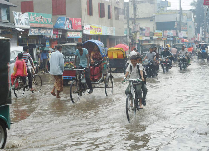 The main roads of Thakurgaon town went under water following moderate rainfall yesterday, exposing the poor drainage system in the district headquarters. The photo was taken from Bangabandhu Road. PHOTO: STAR