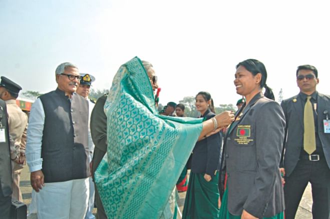 Prime Minister Sheikh Hasina giving 'President Ansar Sheba Podok-2012'  to Rehana Pervin. PHOTO: STAR