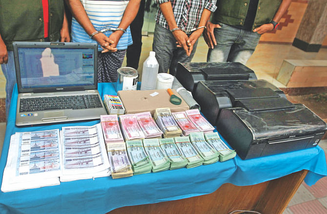The Detective Branch of police shows the media the fake bank notes, paper for the notes, printers, ink and other chemicals they had seized from two fraudsters. The photo was taken at the DB media centre in the capital yesterday.  Photo: Star