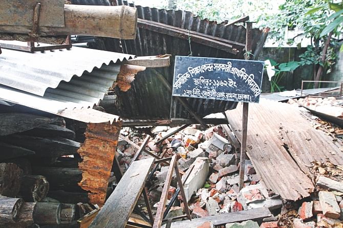 Only the sign board of the school still remains standing amid the rubble of the razed structure.  Photo: Palash Khan