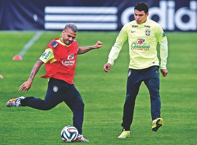 Brazil's Daniel Alves (L) and Thiago Silva take part in a training session in Teresopolis on Thursday as they prepare to take on the Netherlands in the play-off today. PHOTO: GETTY IMAGES