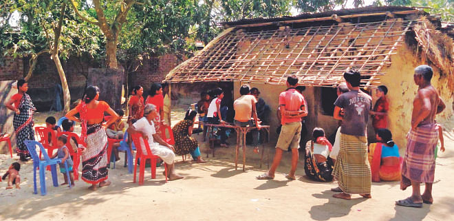 The Hindus of Kornai village in Dinajpur gather for a discussion a day before the third phase of the upazila elections today. The minorities had become victims of communal violence just after the national elections and yesterday a hay stack was torched spreading panic in the locality. Photo: Star