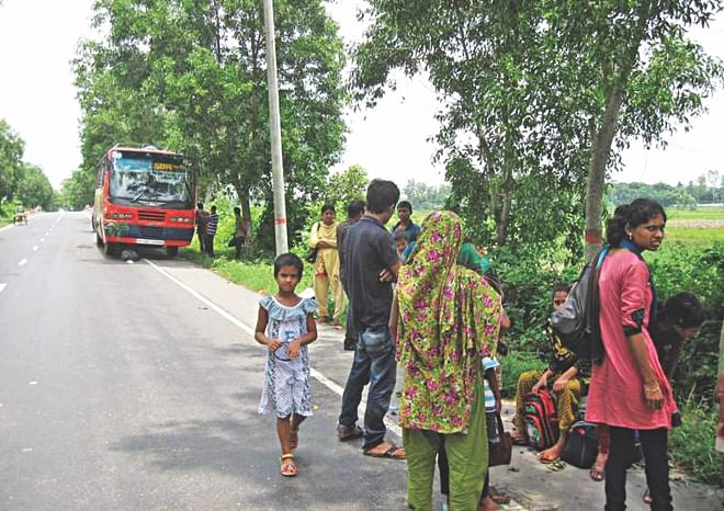 This Faridpur-bound bus went out of order on Dhaka-Aricha highway at Pachuria in Ghior upazila under Manikganj district on Friday, causing untold sufferings to passengers who had to wait a couple of hours before getting an alternative transport.  PHOTO: STAR