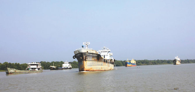 Cargo vessels moving through the Shela river in the Sundarbans. The route was reopened on Wednesday after remaining closed for about a month following a tanker oil spill on December 9. Photo: Collected
