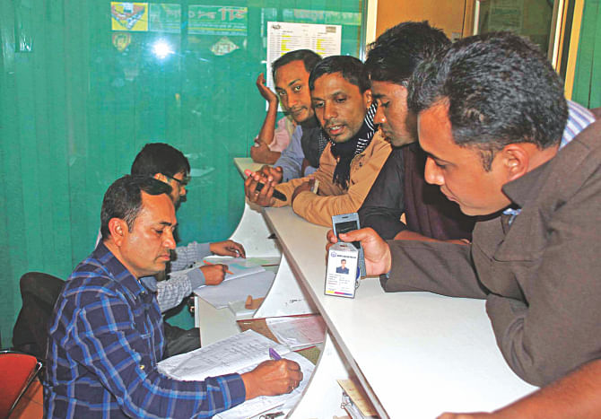 Staff at a ticket counter at Barisal Launch Terminal are reserving tickets after checking the national identity cards of passengers yesterday. Law enforcers, launch operators and terminal officials at a recent meeting decided to check the NIDs of passengers after criminals posing as passengers had attempted arson attacks on two launches.   Photo: Star