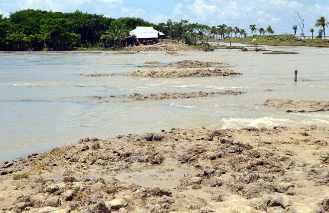 High tide affected by the full moon presently floods 13 villages of Lalua union in Kalapara upazila under Patuakhali district every day.  PHOTO: STAR