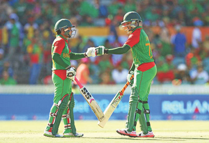 Shakib Al Hasan (R) and Mushfiqur Rahim compliment each other during their match-winning partnership against Afghanistan yesterday. Photo: Collected