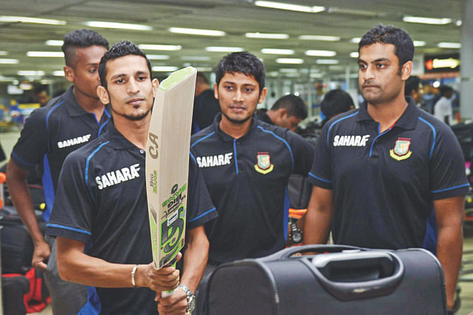 Will this bat bring good times for Nasir? ... Bangladesh cricket team members at the Hazrat Shahjalal International Airport prior to their departure for the West Indies last night. PHOTO: STAR