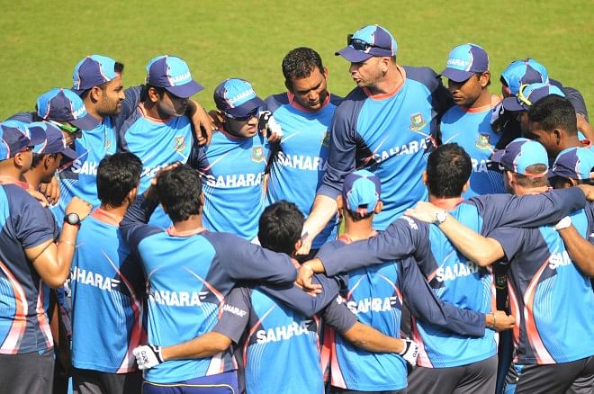 The Bangladesh team, along with coach and support staff, gather in a huddle for a pep talk during practice at the Sher-e-Bangla National Stadium yesterday, ahead of the first Test against Sri Lanka starting here tomorrow.  PHOTO: STAR