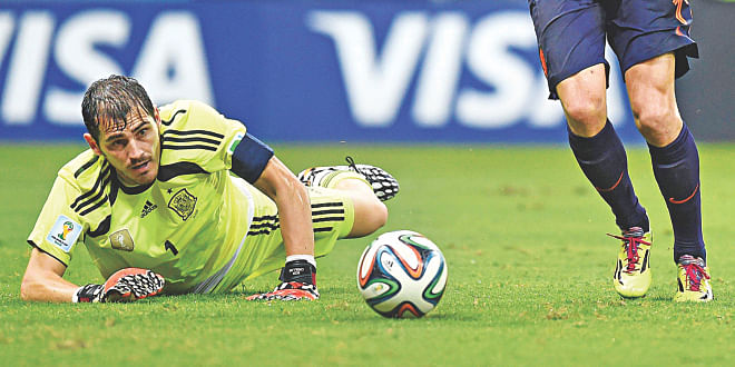 Iker Casillas (grounded) was unbeatable under the bar for a staggering 433 World Cup minutes going into Spain's opening match against the Netherlands. But his record was shattered in a most painful fashion at the Arena Fonte Nova on Friday, when he conceded five and his side suffered a humiliating 5-1 defeat.  Photo: AFP