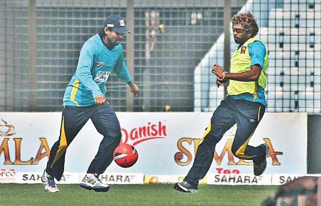 Sri Lanka's short-form specialists Tillakaratne Dilshan and Lasith Malinga, who joined the squad for the limited-overs leg of the tour starting on Wednesday with the first T20I, play a game of football to warm up before practice in Chittagong yesterday. PHOTO: STAR