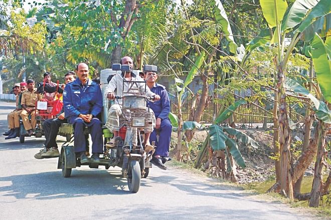 Law enforcers are taking election materials to polling centres in Atghoria upazila of Pabna yesterday, a day before the upazila election Photo: Star