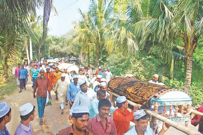 Bodies of several victims in Monday's road crash in Natore being taken to a graveyard in Sidhuli village of Natore for burial. Of the 33 dead, 12 belonged to the village. The photo was taken yesterday.   Photo: Star