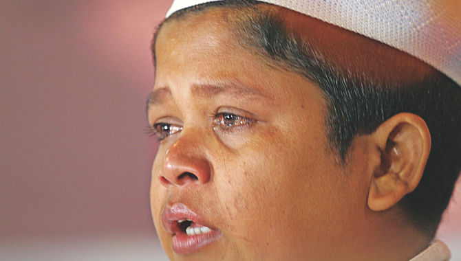 Tears welled up in Mehedi Hasan's eyes at the Jatiya Press Club auditorium yesterday. His elder brother Shahnoor Alam was reportedly picked up by Rab personnel in Comilla on April 29 and allegedly tortured to death a few days later.   Photo: Palash Khan