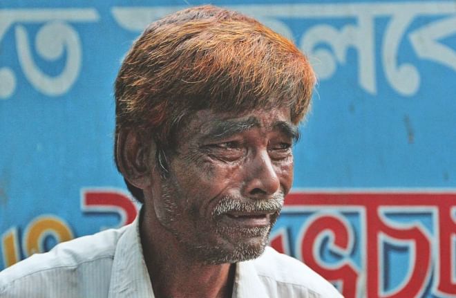 Jashim's father in tears at a clinic in Chittagong yesterday after seeing his son's body. Jashim, a worker at a ship-breaking yard in Sitakunda, was killed in an accident inside a ship along with three fellow workers.  Photo: Anurup Kanti Das