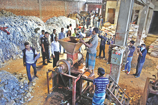 A mobile court backed up by Rab raids a factory in Hazaribagh in the capital yesterday where leather strips, allegedly tainted with chromium, was being used for making poultry feed.  Photo: Rashed Shumon