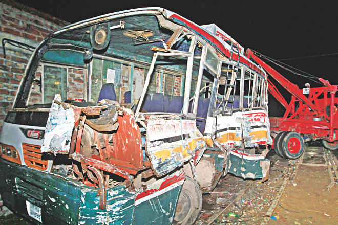 The wreckage of the bus hit by a train at TT Para level crossing in the capital's Kamalapur area last night. The accident occurred as the vehicle was travelling on the wrong side of the road. At least three people were killed and 13 others injured. Photo: Star