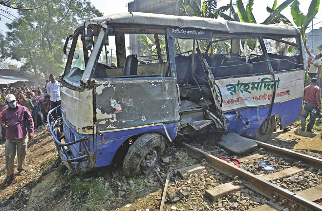 The wreckage of the bus hit by a train at Chandgaon in Chittagong city. The accident left four garment workers dead. Photo: Star