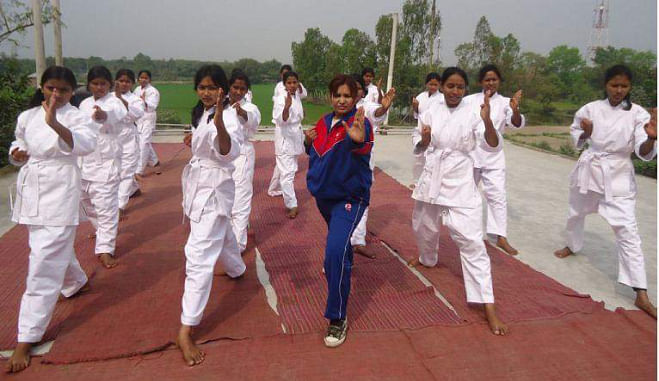 A group of karate trainees, comprising female students of a few schools in Dimla upazila under Nilphamari district, practise the martial art on the premises of Dimla Girls' High School a couple of days ago. PHOTO: STAR