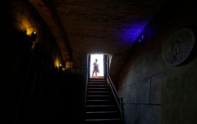 A girl stands in the entrance to the cellar where the company TRAP operates two escape room games in Budapest August 1, 2014. Photo: Reuters 
