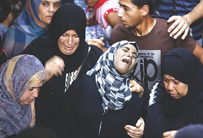 Relatives of Hasan Baker, a 60-years-old Palestinian, grieve during his funeral in Gaza City yesterday. A series of Israeli air strikes earlier killed seven people in Gaza, including five members of the same family. Photo: AFP