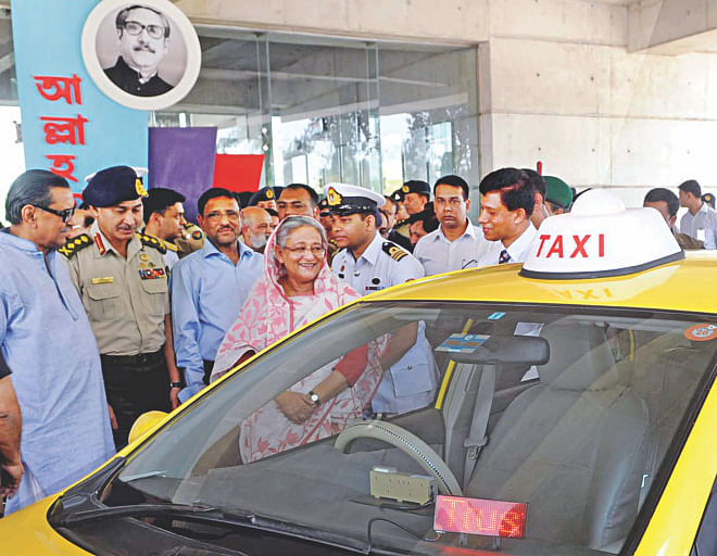 Prime Minister Sheikh Hasina inaugurates the taxicab service of Trust Transport Services at the Army Golf Club in Dhaka Cantonment yesterday. Photo: BSS