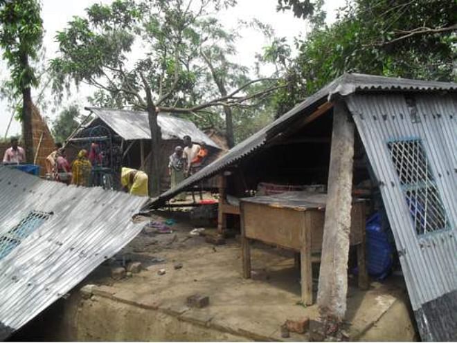 Two houses lie mangled at Baruria village in Chatmohor upazila of Pabna as nor'wester lashed the area on Wednesday night. Photo: Star