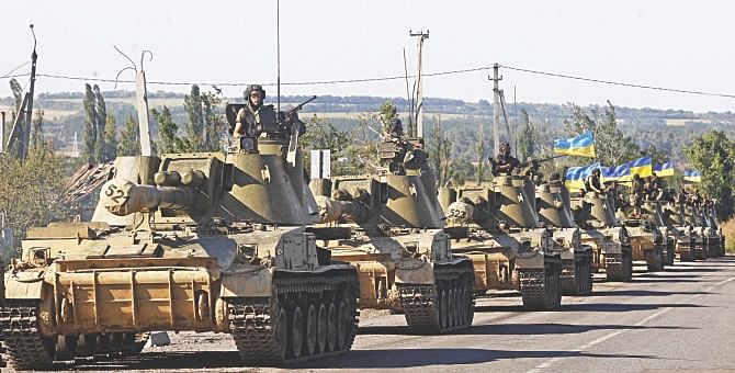 A column of Ukrainian tanks travels in Donetsk region yesterday. Beleaguered Ukrainian President Petro Poroshenko announced that he and his Russian counterpart Vladimir Putin had agreed a surprise truce in Ukraine's four-month war with pro-Moscow rebels. Photo: AFP