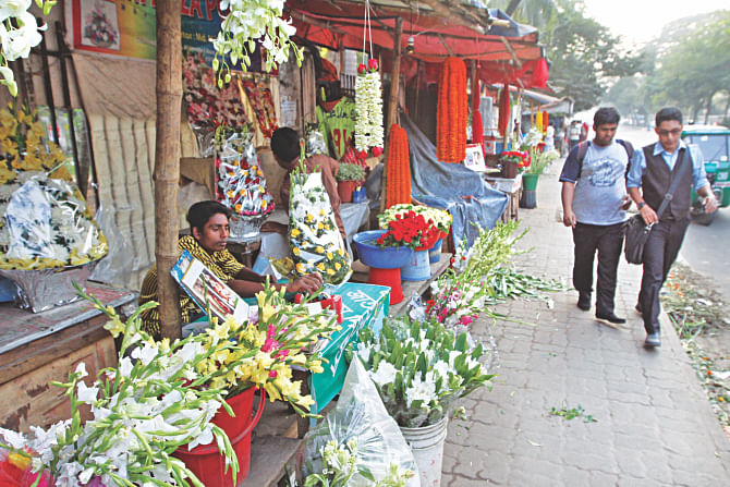 Some of the unauthorised makeshift flower shops occupying the footpath to the north of Anwar Park along Khamarbari road in the capital's Farmgate.   PHOTO: STAR