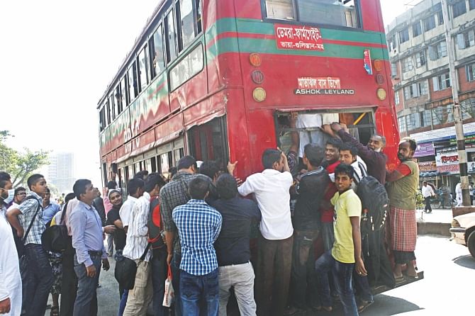 People push and elbow each other in a desperate bid to get a footing on a state-owned bus in the capital's Kalyanpur yesterday amidst a dearth of privately run buses, most of which stayed off the streets and parked by the roads as the inset shows at Gabtoli due to a government clampdown on unfit vehicles and on drivers, who either do not have licenses or carry fake ones, through six mobile teams mainly focusing on the capital. The photos were taken around midday. photo: star