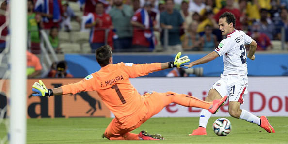 Costa Rica's forward Marco Urena (R) scores his team's third goal against Uruguay's goalkeeper Fernando Muslera during a Group D football match between Uruguay and Costa Rica at the Castelao Stadium in Fortaleza during the 2014 FIFA World Cup on June 14, 2014. Photo: AFP/Getty Images