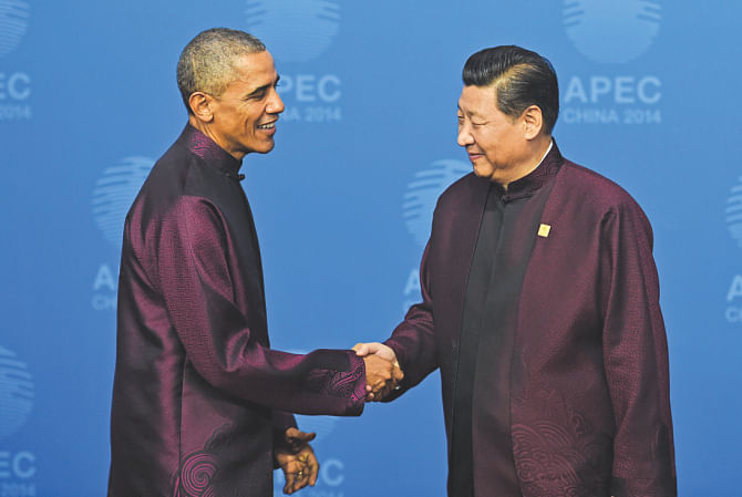 US President Barack Obama is greeted by Chinese President Xi Jinping as he arrives for the APEC Summit banquet in Beijing yesterday.  Photo: AFP