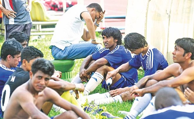 Players and officials of Uttar Baridhara Club on Sunday ended a bitter top flight campaign with a 6-0 drubbing by Sheikh Jamal Dhanmondi Club that also confirmed their demotion from the Bangladesh Premier League at the Bangabandhu National Stadium yesterday. PHOT: STAR