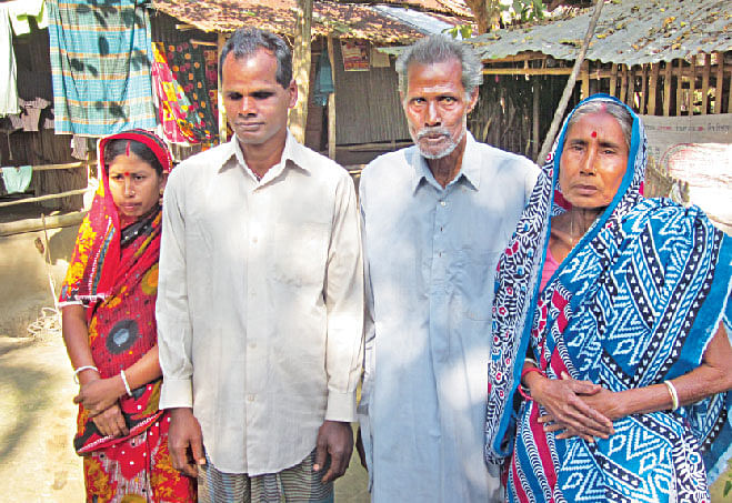 Ronjon Biswas with wife Shopno Biswas and his parents at their home in Rundia village, Narail. Photo: Andrew Eagle