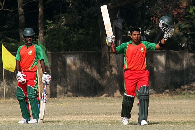Shaheed Jewel XI batsman Rokibul Hasan acknowledges the crowd’s applause after scoring a century against Shaheed Mushtaque XI in the Victory Day exhibition cricket match at the Dhanmondi Cricket Stadium yesterday. PHOTO: STAR
