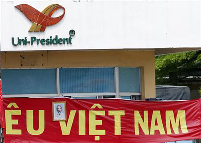 A portrait of the late Vietnamese revolutionary leader Ho Chi Minh is displayed on a sign reading, 