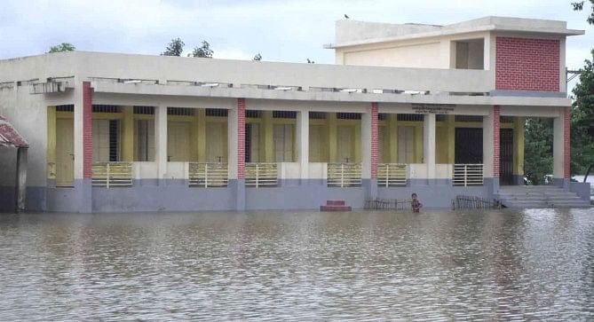 The ground of Hariswar Taluk High School in Rajarhat union of Rajarhat upazila under Kurigram district remain under water as flash floods inundated large areas of the two districts in last couple of days.  PHOTO: STAR